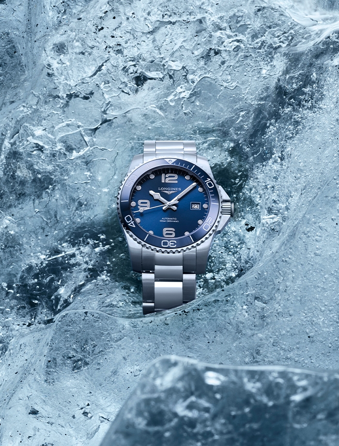 Longines Sport watch with with stainless steel bracelet and round blue dial.